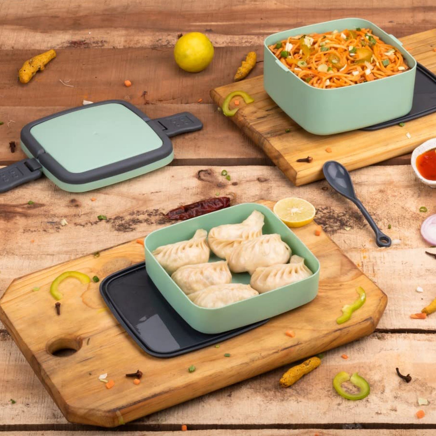 Green lunch box with handle and spoon for easy carrying