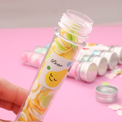 Test tube containing flower-shaped paper soap strips for travel.